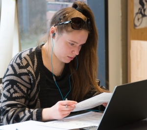 Student with a laptop near a window